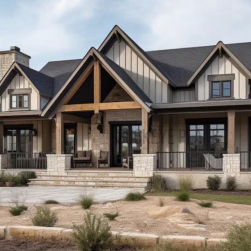 A charming home with a spacious front porch, surrounded by lush greenery.