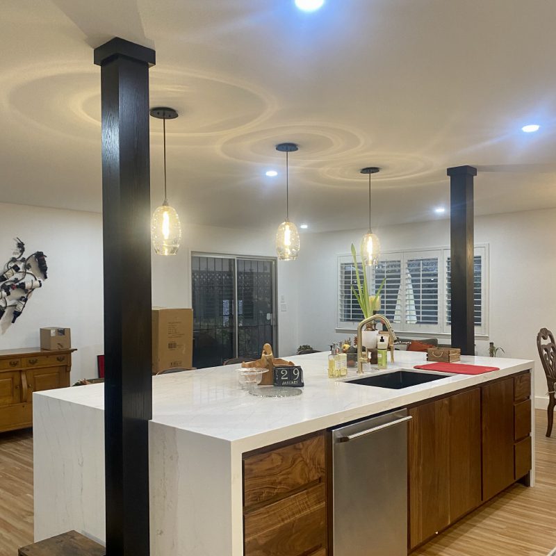 A spacious kitchen featuring a sizable island and a sink for convenient meal preparation and clean-up.