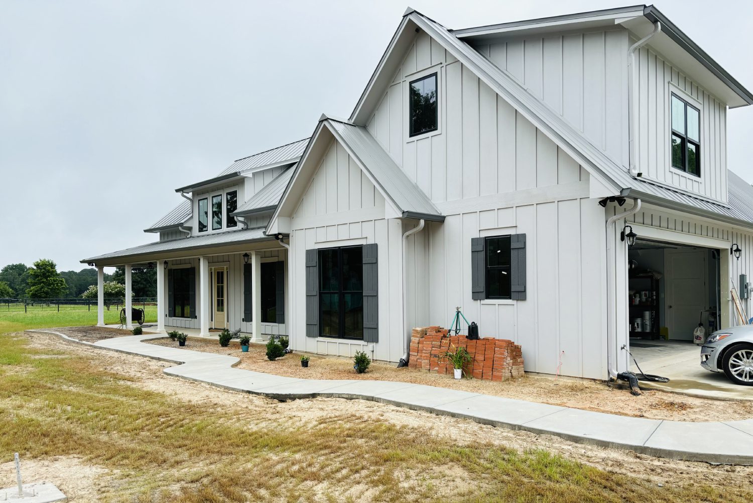 White house with garage and driveway.