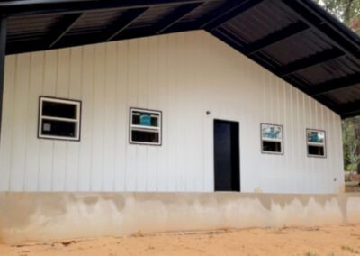 A small white building with black trim and windows.